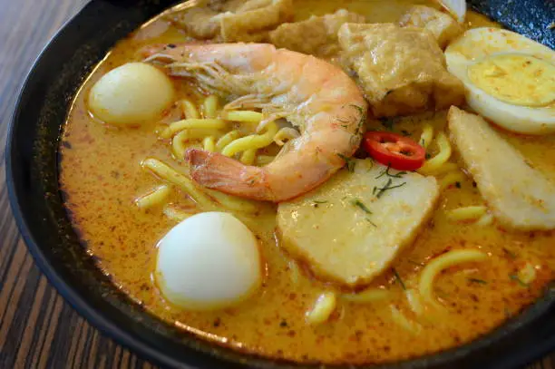 Singapore style seafood noodles in curry soup
