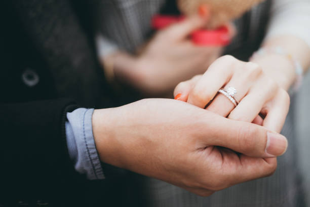 istock Close-Up Of Couple Holding Hands 1295707412