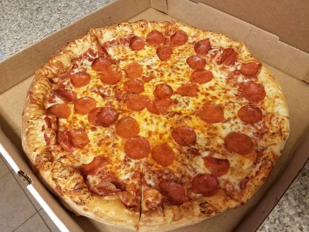 istock pepperoni pizza in cardboard box on counter 1295711750