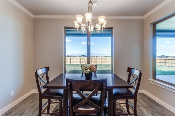 istock Simple dining room with dark wood table 1295716926