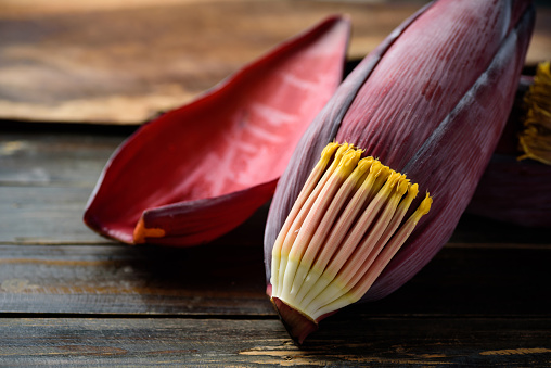 Banana flowers on wooden background, Edible plant in Southeast Asian cuisine, food ingredients in salad, curry or soup