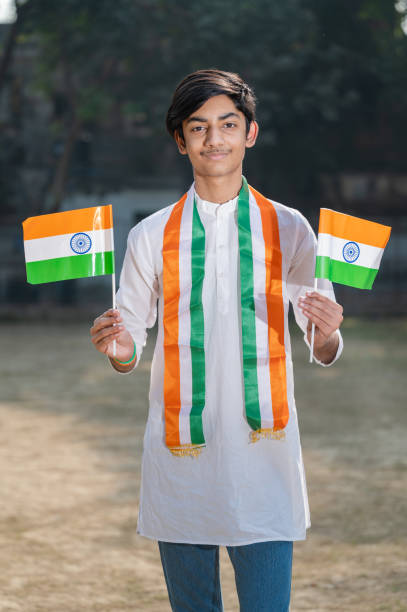 Young Indian boy child with Indian National Tricolor flag, celebrating Independence day or Republic Day of India.