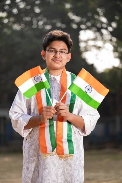 istock Young Indian boy with Tricolor Indian flag 1295718780
