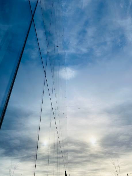 istock Cirrus Clouds with a Reflective Glass Building 1295719620