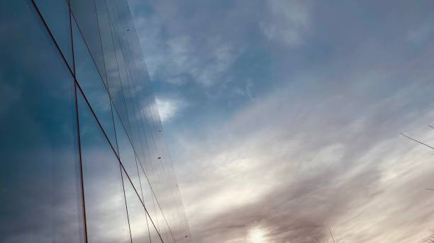istock Cirrus Clouds with a Reflective Glass Building 1295719632