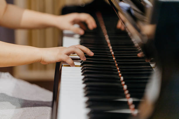 istock Young woman playing piano in studio 1295719755