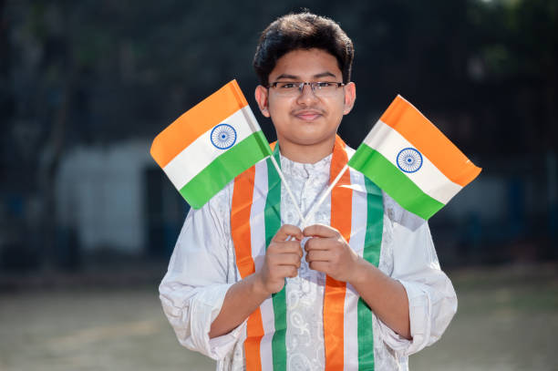 istock Young Indian boy with Tricolor Indian flag 1295720504