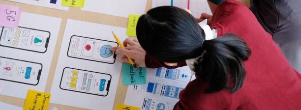 istock Brainstorm planing creative asian teamwork, Group of asia mobile phone app developer team meeting for ideas about screen display prototype smartphone layout, ux startup small business 1295722407