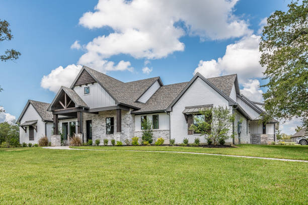 istock Beautiful white and stone facade on home 1295723508