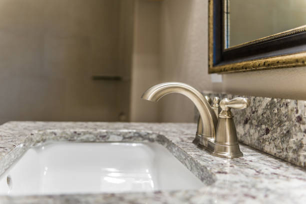 istock Close up of double handle faucet in bathroom 1295724925