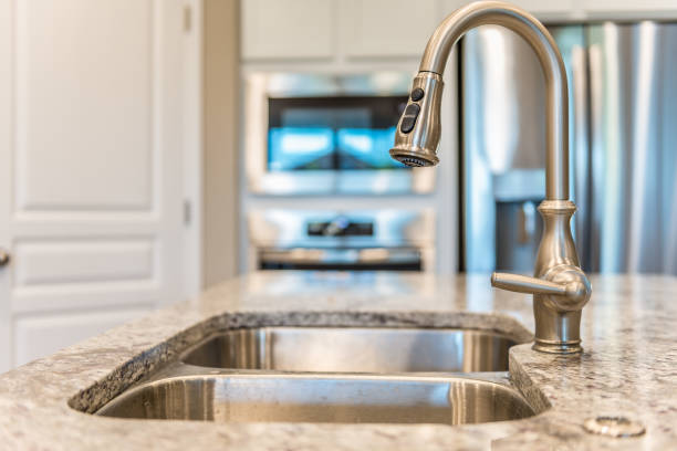istock Close up view of pull down faucet in kitchen 1295724927