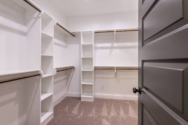 istock Built in white shelving in master closet 1295725832