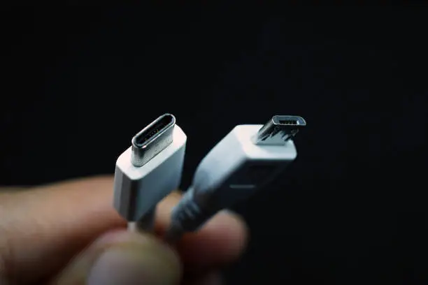 Photo of Hand holding Micro USB and type c usb cable.