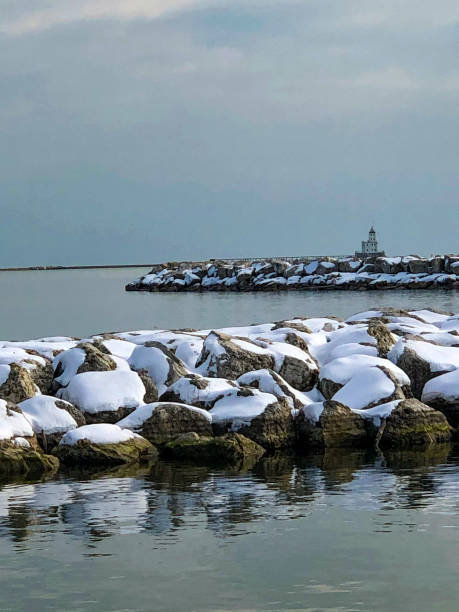 istock Snowy rocks on Lake Michigan 1295728160