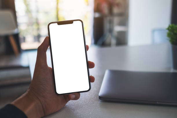 istock a hand holding mobile phone with blank white screen 1295729741