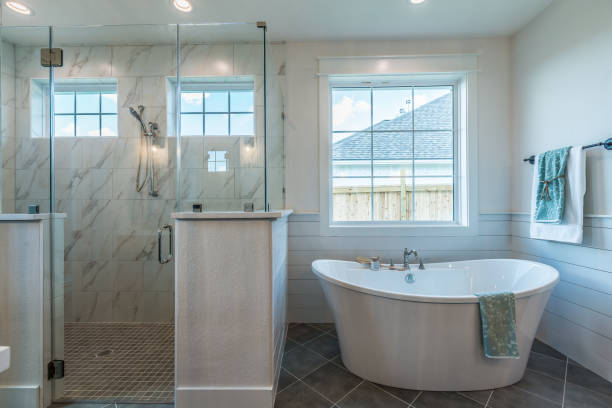 istock Freestanding bathtub next to spacious shower 1295731738