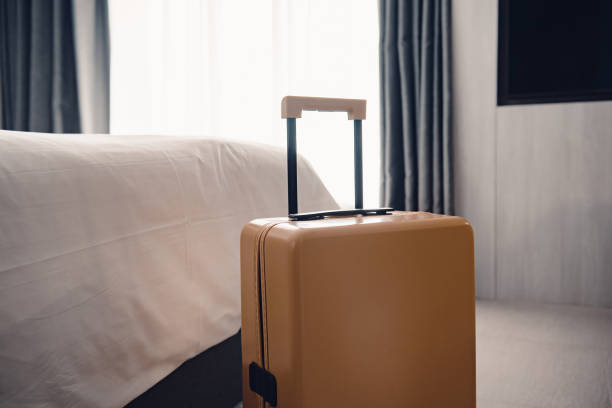 istock Suitcase or luggage bag in a modern hotel room. 1295732506