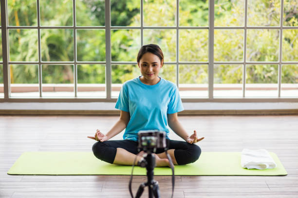 istock Yoga trainer shoots video at camera. Online content 1295734120