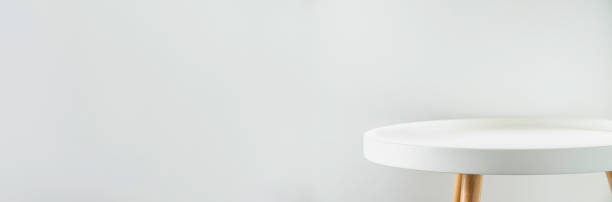 istock Banner empty modern round white table top at white house wall,Mockup space background for display or montage of product for advertising online 1295734801