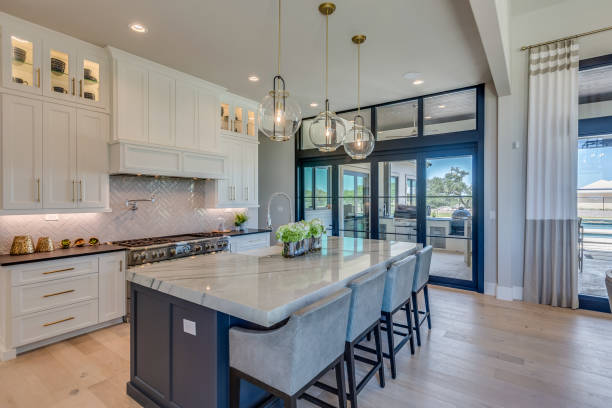 Wood flooring in white kitchen Lots of glass doors and windows lending natural light to the home kitchen stock pictures, royalty-free photos & images