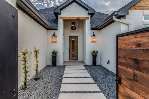 istock Unique entrance to home with vertical window on front door 1295737410