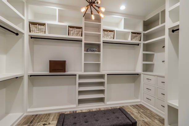 Built in shelves in luxury master closet Modern light fixture in center of walk-in closet customized stock pictures, royalty-free photos & images