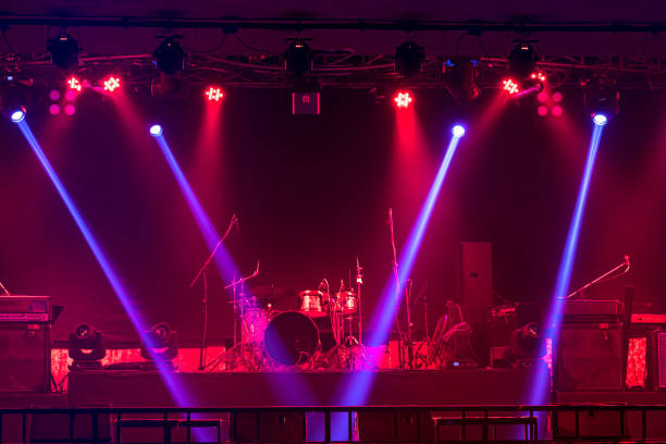 istock Musical instruments with spotlight on the stage with light ray  in conference hall or nightclub, party and celebrate, happy new year and merry Christmas concept, dump, guitar, microphone, 1295738227