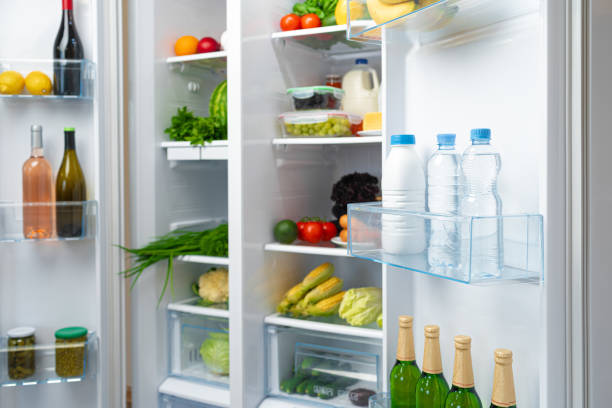 istock Open fridge full of fruits, vegetables and drinks 1295738485