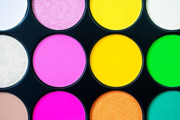 istock Multicolored neon eyeshadow palette. Make-up. Beauty products. Bright colorful beautiful background. Tool for makeup artist. Cosmetic. Visagiste. Beauty shop. Summer eye shadow. Yellow, pink, green. 1295739415