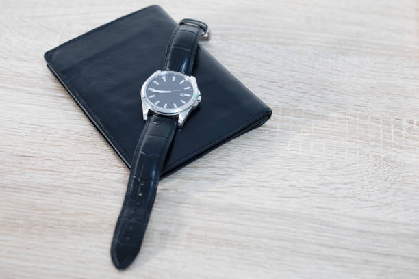 istock Men's watch and wallet on the table 1295740357