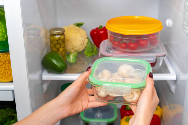 istock Female hands taking storage box with food from a fridge 1295741652