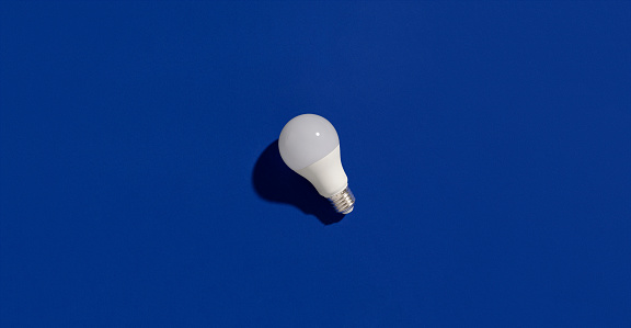 LED energy saving light bulbs on blue background. Sustainable lifestyle eco-friendly concept