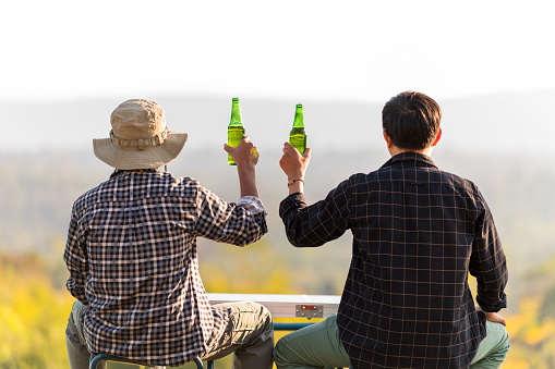 Two men are friends living healthy lifestyle and relax Cheering with beer and And Drinking Bee