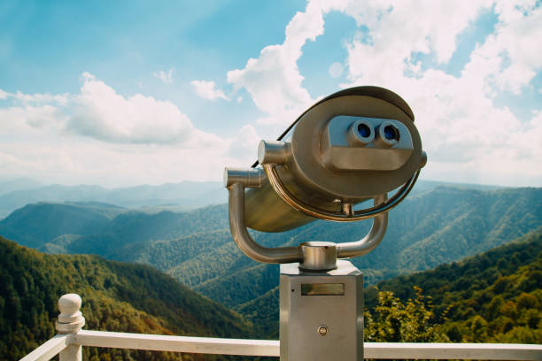 istock Binoculars with coins overlooking the Blue Mountains, Landscape with beautiful cloudy sky and mountains .. 1295744705