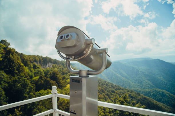 istock Binoculars with coins overlooking the Blue Mountains, Landscape with beautiful cloudy sky and mountains .. 1295744709