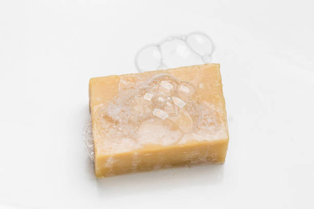 Soap bar and foam on white background