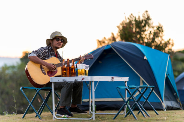 istock Men with Acoustic Guitar And Drinking Bee 1295745565