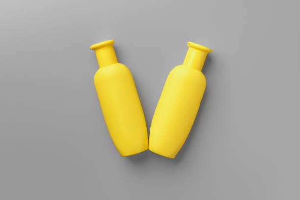 istock Yellow cosmetic container on gray background top view 1295750053