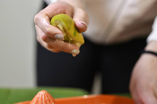 istock squeezing oranges and limes by hand for juice 1295752415