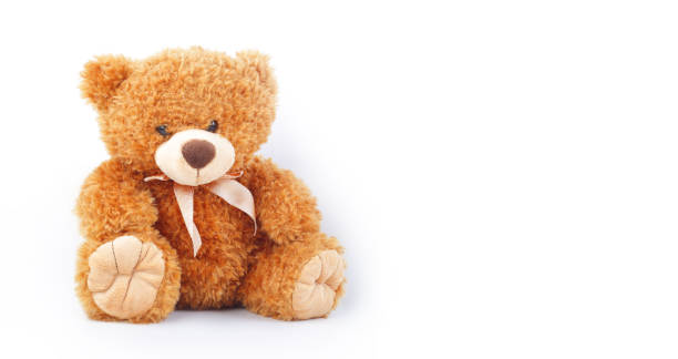istock Toys - Baby teddy bear sits on white 1295752678