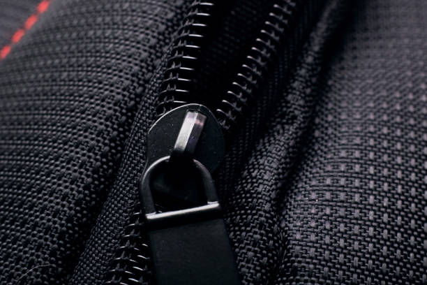 istock Lock and zipper on black fabric close up 1295752719