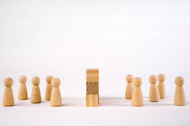 istock Two different groups of people standing facing to each wood cube wall 1295752934