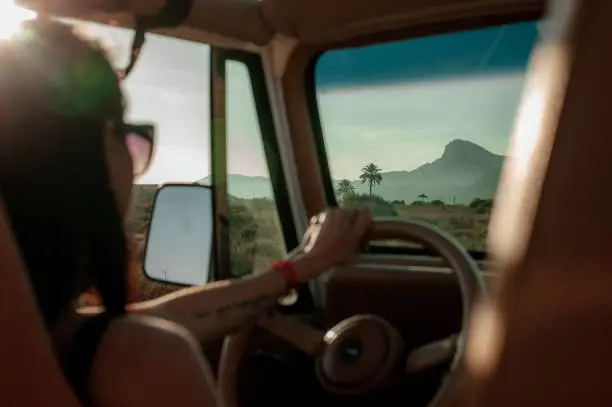 Photo of Woman driving a 4x4 off desert road
