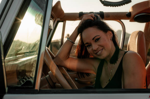 istock Woman driving a 4x4 smiling at camera 1295753892