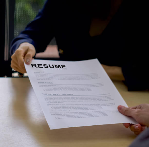 istock Candidate handing resume to human resource manager before start the interview. Close up 1295754032
