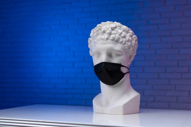 istock A white plaster statue wearing a disposable protective medical mask covering its face 1295754838