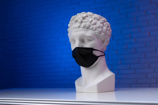 istock A white plaster statue wearing a disposable protective medical mask covering its face 1295754845