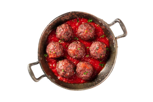Meatballs with tomato sauce in a skillet, isolated on a white background Meatballs with tomato sauce in a skillet, isolated on a white background with a clipping path cooking pan overhead stock pictures, royalty-free photos & images
