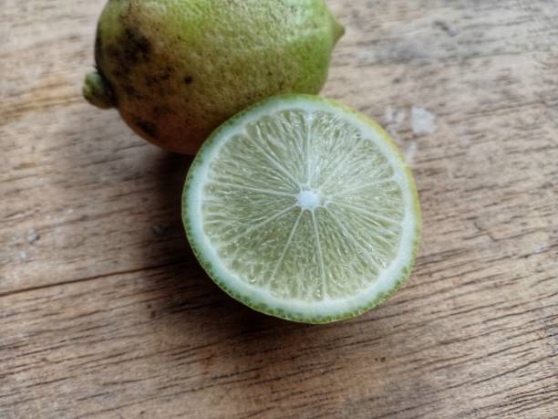 istock lemon against a wooden table background 1295755157