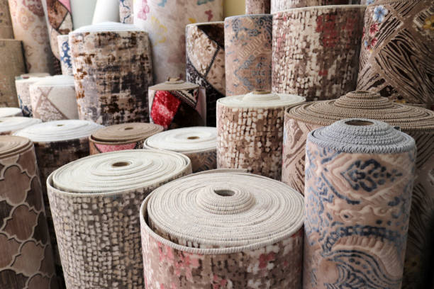 various rugs in the carpet shop. home decoration. - textile textile industry warehouse store imagens e fotografias de stock